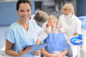 smiling dental assistant at dental office