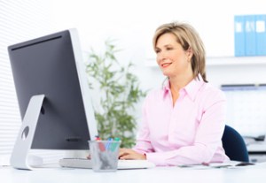 woman using a computer to fill out her patient registration